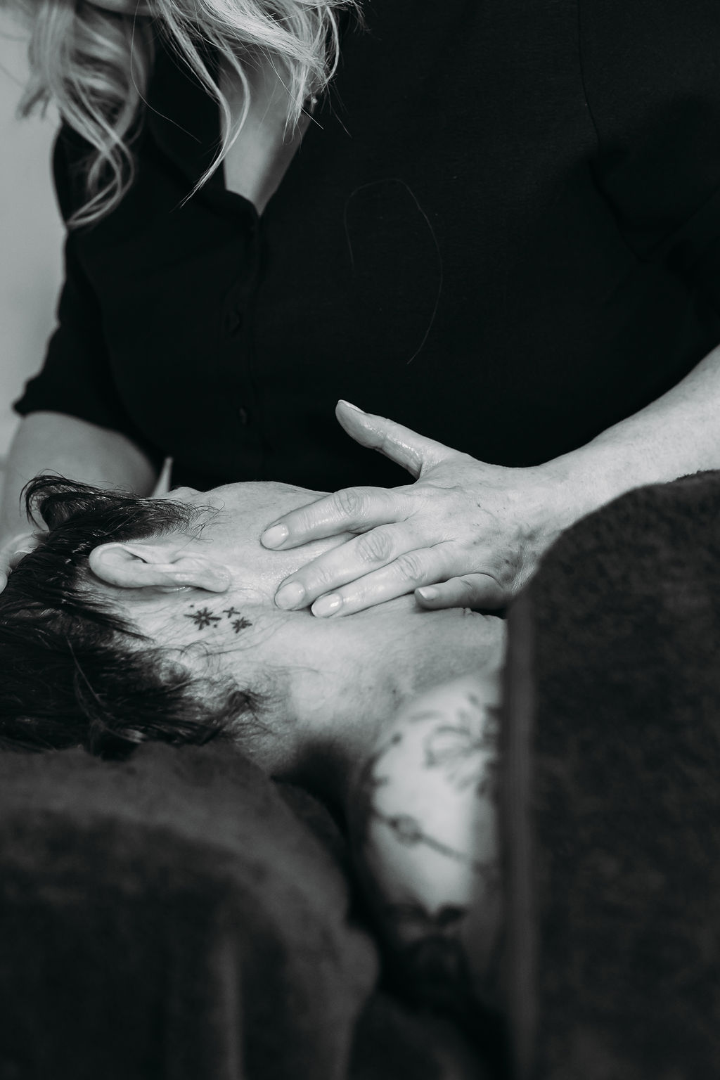 Facial massage for menopause and nervous system reset including vegas nerve. Black and white image of massage in progress